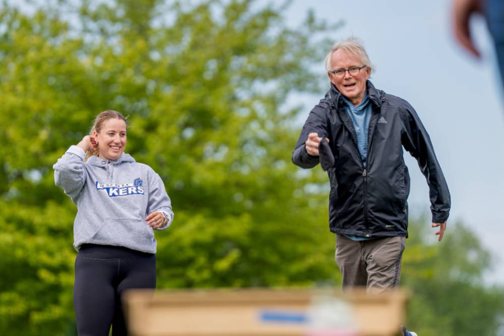 Bryan Bickford throws a bag and smiles
